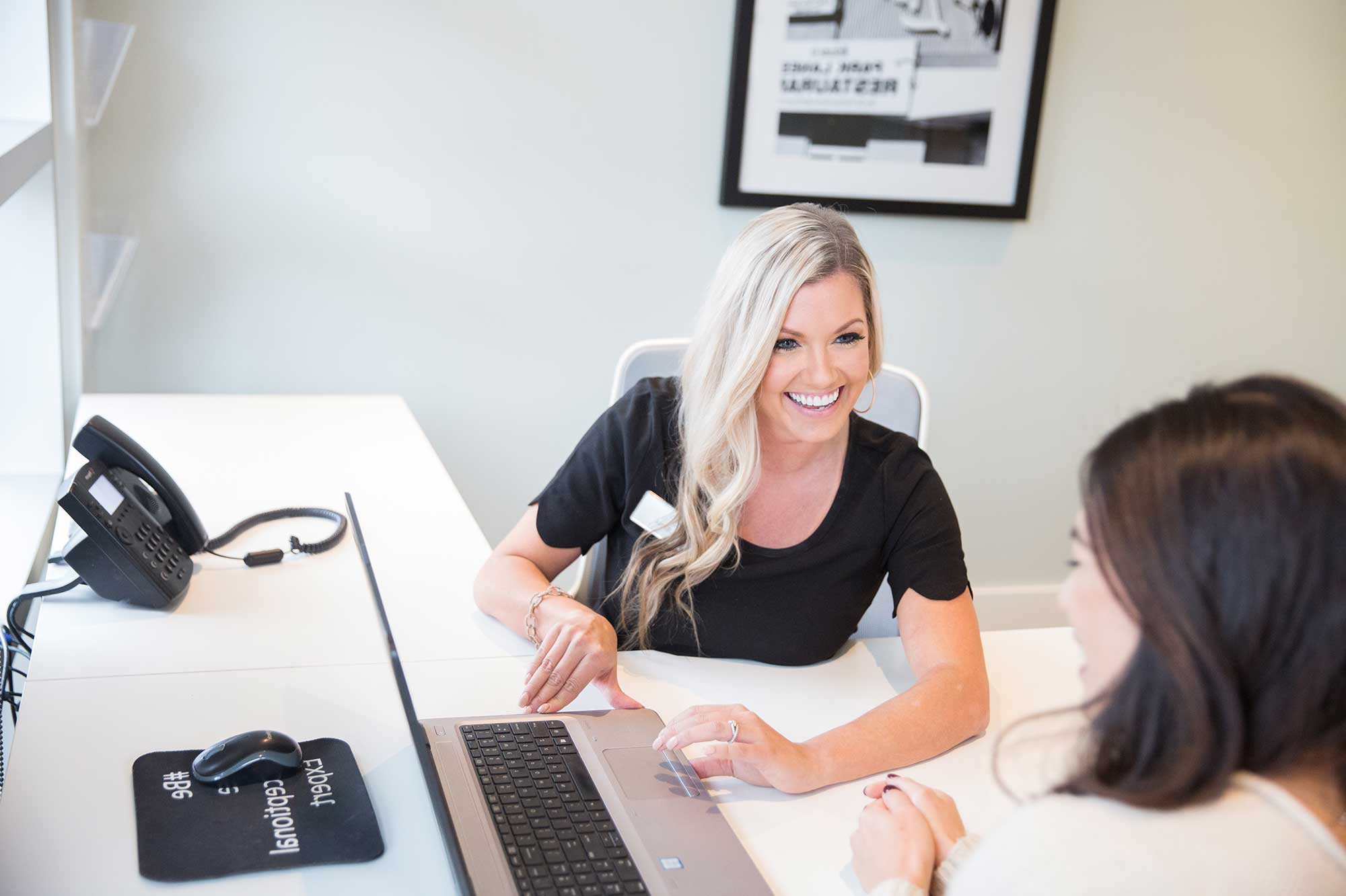 a woman sitting at a desk with a laptop