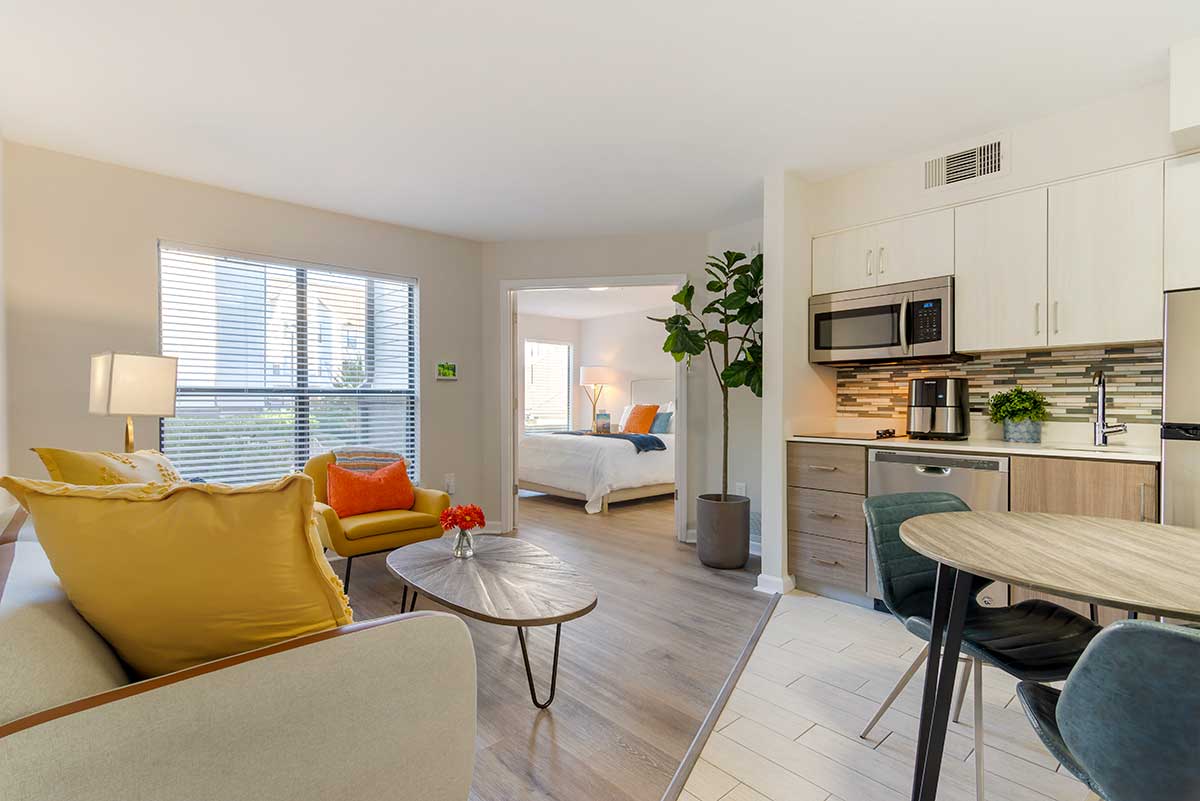 a living room with a kitchen and dining area