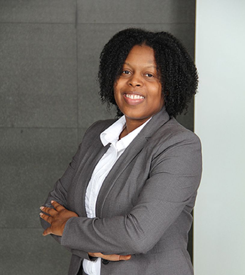 a woman in a suit with her arms crossed